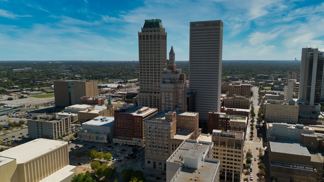 Tall skyscrapers dominate a sunny urban cityscape.
